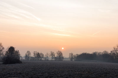 Scenic view of field against sky during sunset