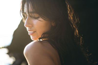 Young latina woman portrait at golden hour in summertime