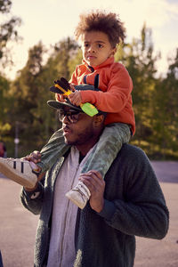 Father carrying boy on shoulders