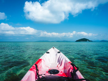 First person view of sea kayak with clear turquoise water and coral reef. koh mak island, thailand.