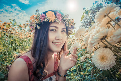 Portrait of smiling young woman against plants