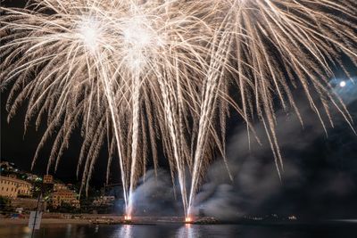 Low angle view of firework display at night