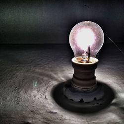 Lit light bulb at night