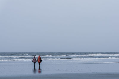 Tourists on the norsee beach of sankt peter-ording in germany