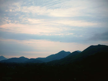 Scenic view of silhouette mountains against sky during sunset