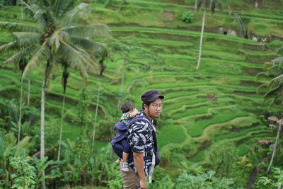 Rear view of man standing on field