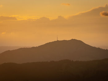 Scenic view of silhouette mountains against sky during sunset