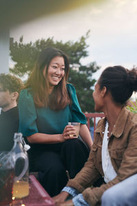 Young women sitting on glass of woman