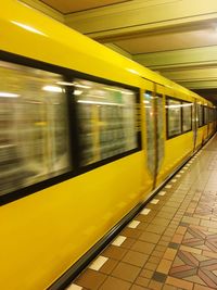 Blurred motion of train at railroad station