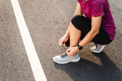 Low section of woman on road