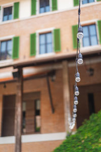 Low angle view of hanging outside building