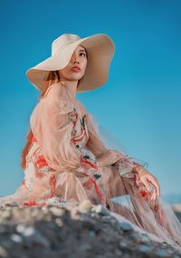 Woman wearing hat against clear sky