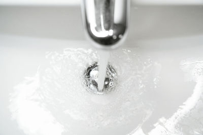 High angle view of water from faucet in bathroom