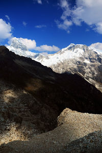 Scenic view of mountains against cloudy sky