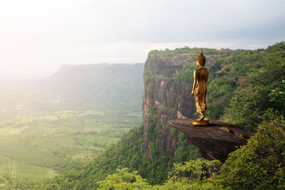 Buddha statue on mountain with nature background