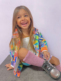 Portrait of young woman sitting on floor