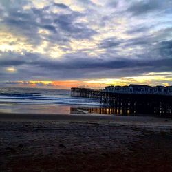 Scenic view of beach against sky during sunset