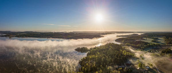 Scenic view of land against bright sun