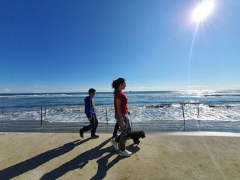 Full length of woman on beach against sky