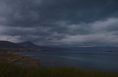 Scenic view of lake and mountains against sky