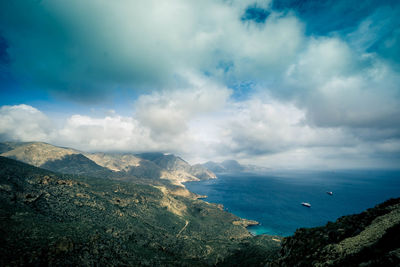 Scenic view of sea and mountains against sky