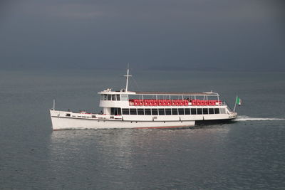 Ship sailing on sea against sky