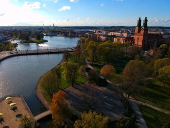 High angle view of river amidst buildings against sky