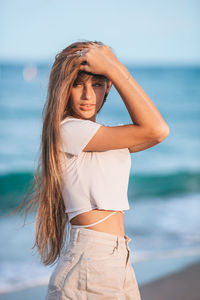 Young woman standing at beach