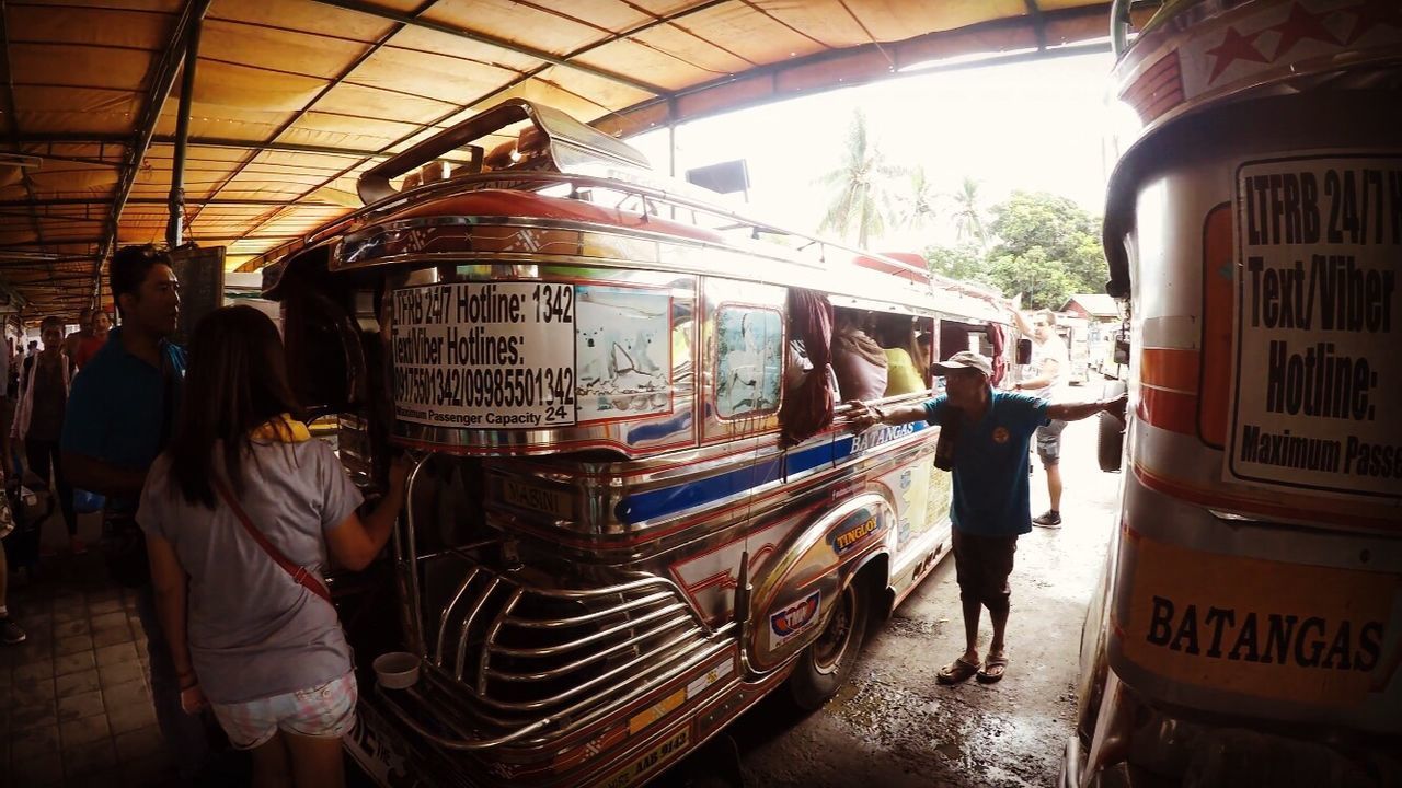 PEOPLE STANDING AT BUS