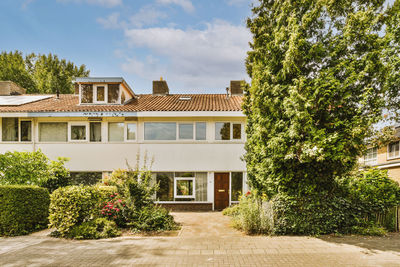 House by trees against sky