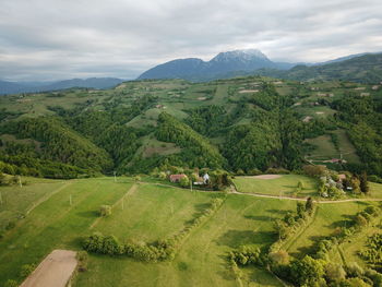 Scenic view of green landscape against sky