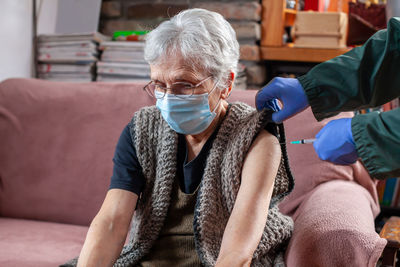 Elderly woman not happy about receiving the vaccine