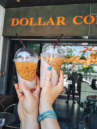 Close-up of hand holding glass of drink