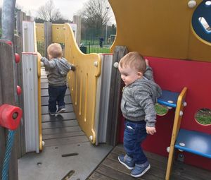 Twin toddler boys playing at playground