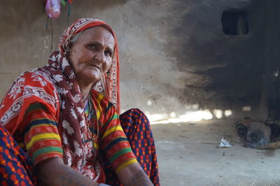 Portrait of woman sitting at home in village