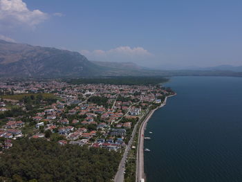 High angle view of townscape by sea against sky