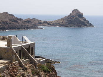 Scenic view of sea and mountains against sky