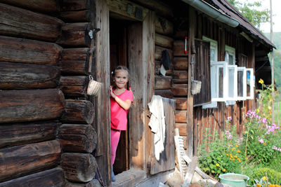 Full length of young woman standing in abandoned house