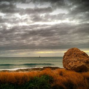 Scenic view of sea against cloudy sky