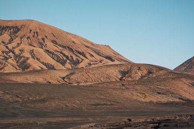 Scenic view of arid landscape against clear sky