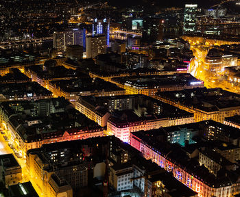 High angle view of illuminated buildings in city at night