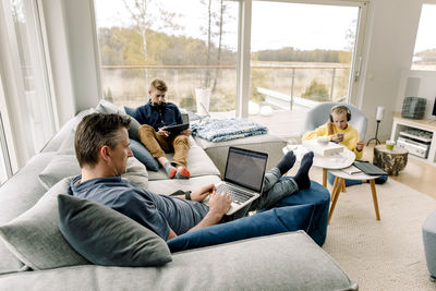 Rear view of men sitting on sofa