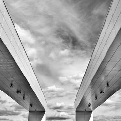 Low angle view of bridge against cloudy sky