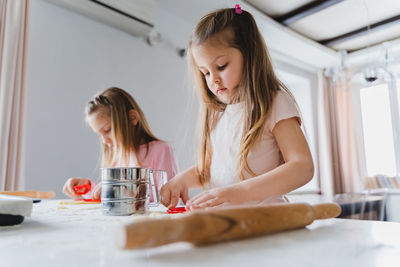 Girl looking away while sitting on table