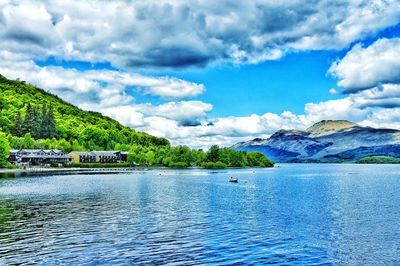 Scenic view of lake against cloudy sky