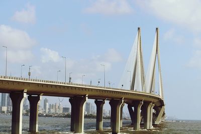 Low angle view of bridge against cloudy sky