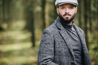 Portrait of man standing in forest