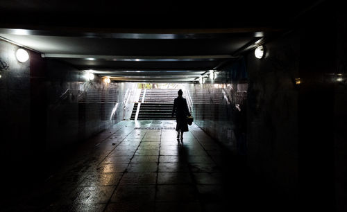 Rear view of silhouette man walking in subway