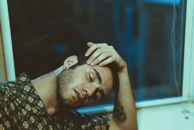 Close-up of young man relaxing at home