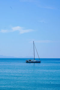 Sailboat sailing on sea against sky